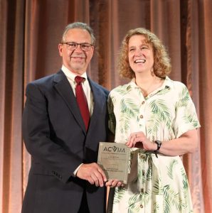 Leah Cohn receives the Lee and Inge Pyle Service Award from Allen Roussel, DVM, MS, DACVIM a professor and department head at Texas A&M College of Veterinary Medicine, and one of the colleagues who wrote letters supporting Cohn’s nomination.